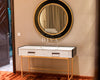 Round mirror with black frame above a console table in a room with 'DIVA HOMES' branding.